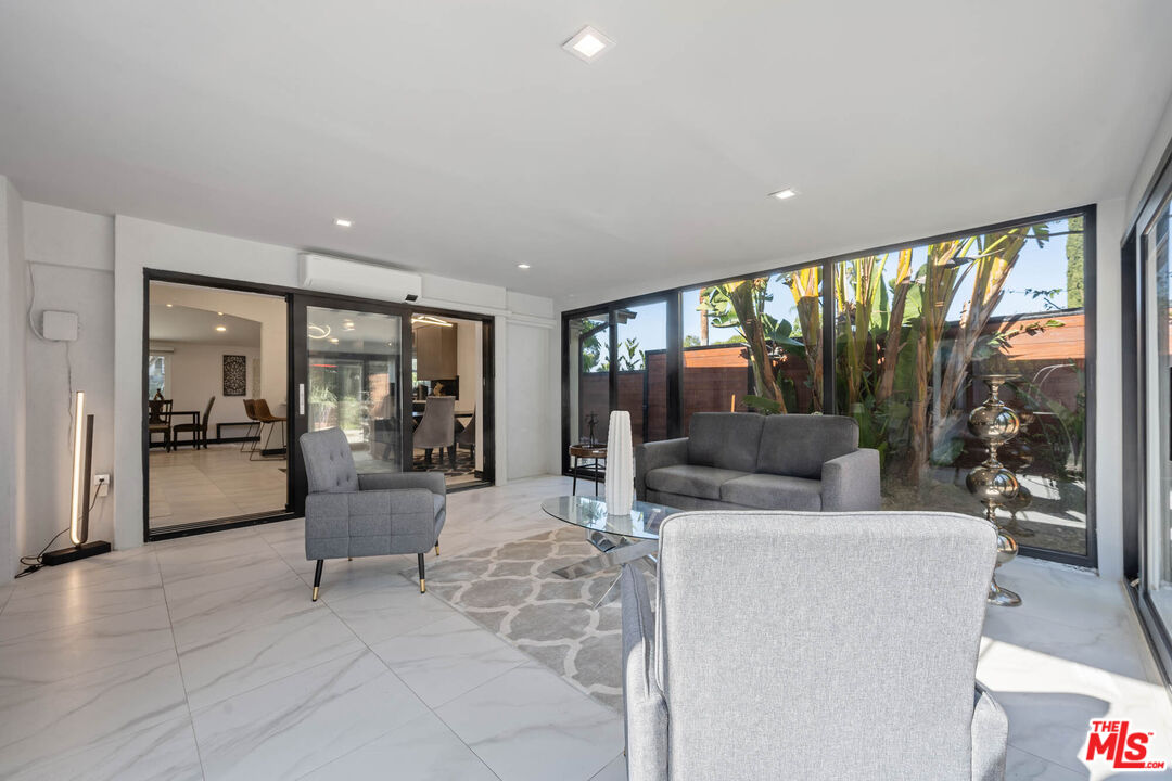 20412 Oxnard Street Woodland Hills, CA 91367 - Photo 4 of 35 a living room with furniture and a large window