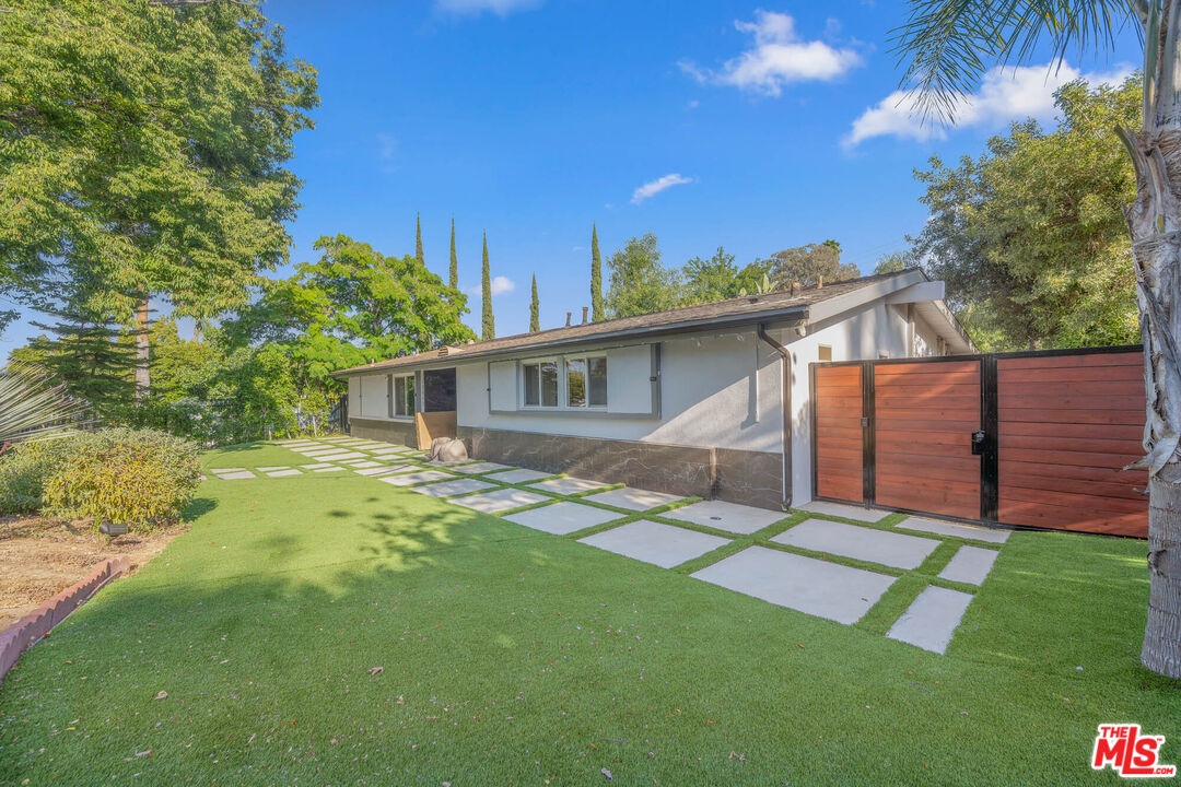 20412 Oxnard Street Woodland Hills, CA 91367 - Photo 5 of 35 a view of a house with a yard
