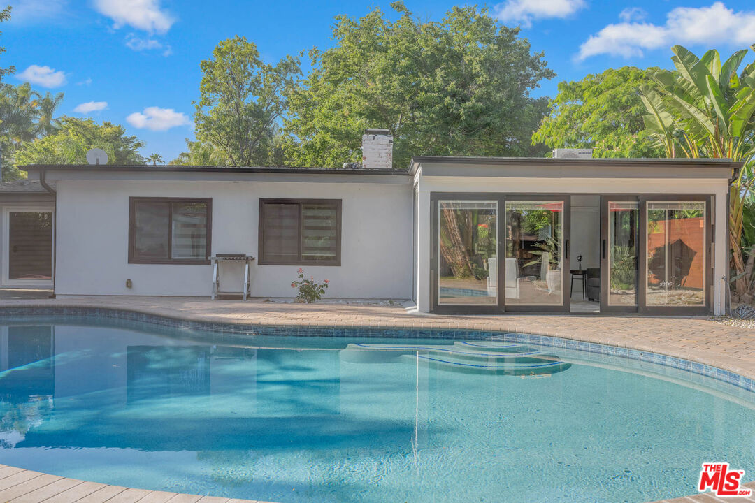 20412 Oxnard Street Woodland Hills, CA 91367 - Photo 6 of 35 a front view of a house with a yard