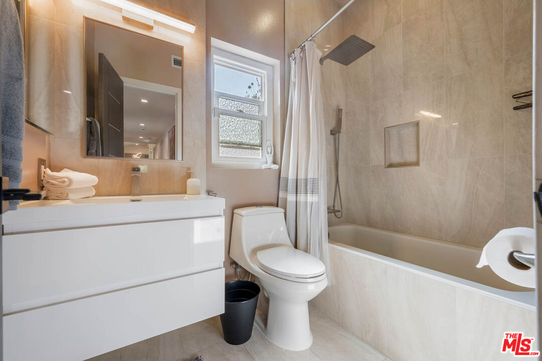 20412 Oxnard Street Woodland Hills, CA 91367 - Photo 9 of 35 a bathroom with a toilet a sink and shower