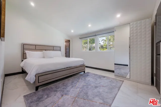 a bed room with a bed and a window