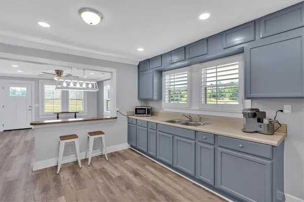 a large kitchen with granite countertop lots of counter space and sink