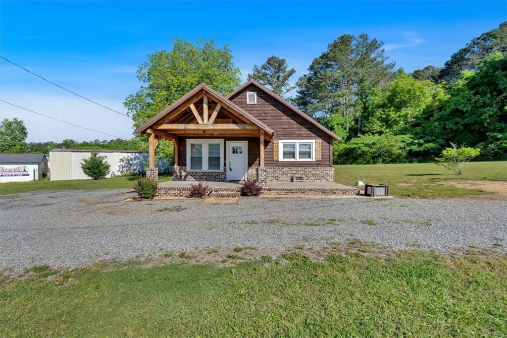 3049 Highway 411 White, GA 30184 - Photo 2 of 49 a front view of a house with a yard and trees