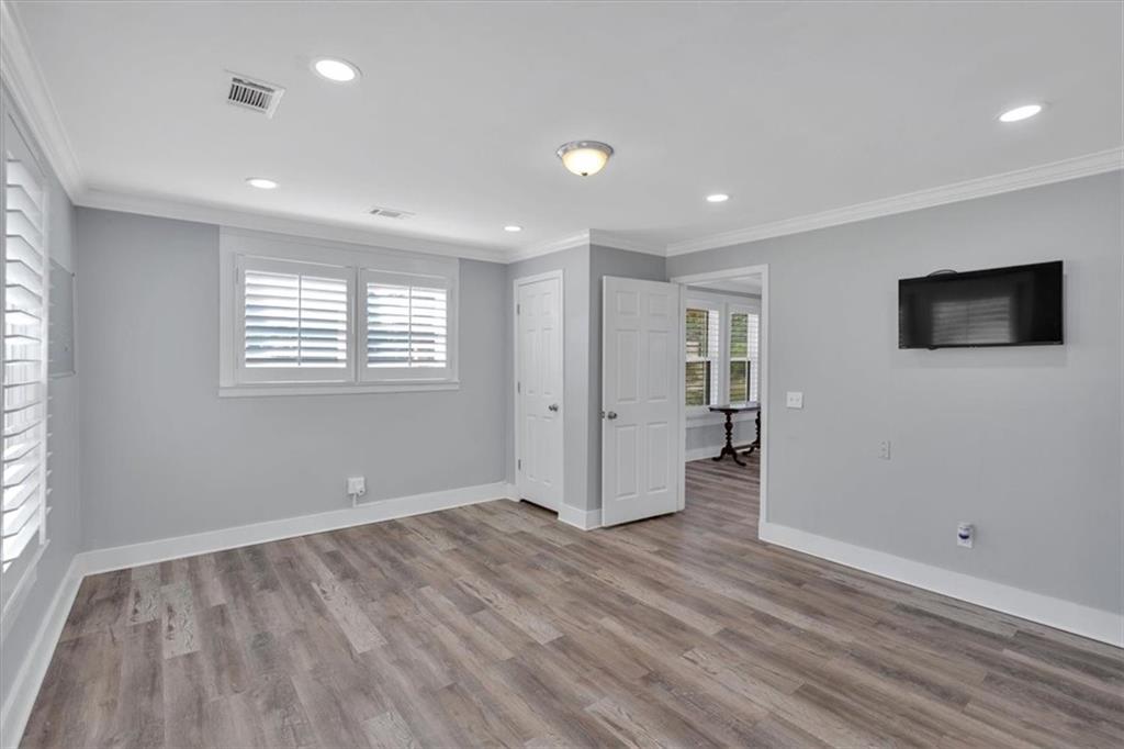 3049 Highway 411 White, GA 30184 - Photo 26 of 49 an empty room with wooden floor and windows