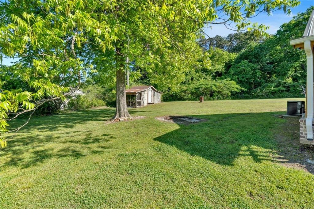 3049 Highway 411 White, GA 30184 - Photo 31 of 49 a view of an house with backyard space and garden
