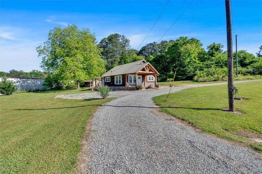 3049 Highway 411 White, GA 30184 - Photo 4 of 49 a house with green field in front of it