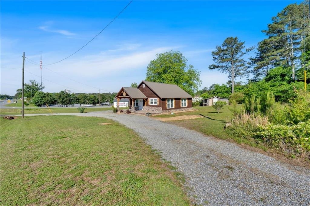 3049 Highway 411 White, GA 30184 - Photo 5 of 49 a view of a house with a yard and potted plants