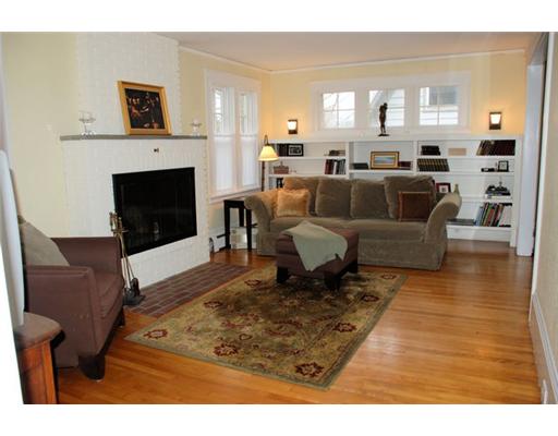 Living Room. Maple floors, woodburning fireplace, built in bookcases