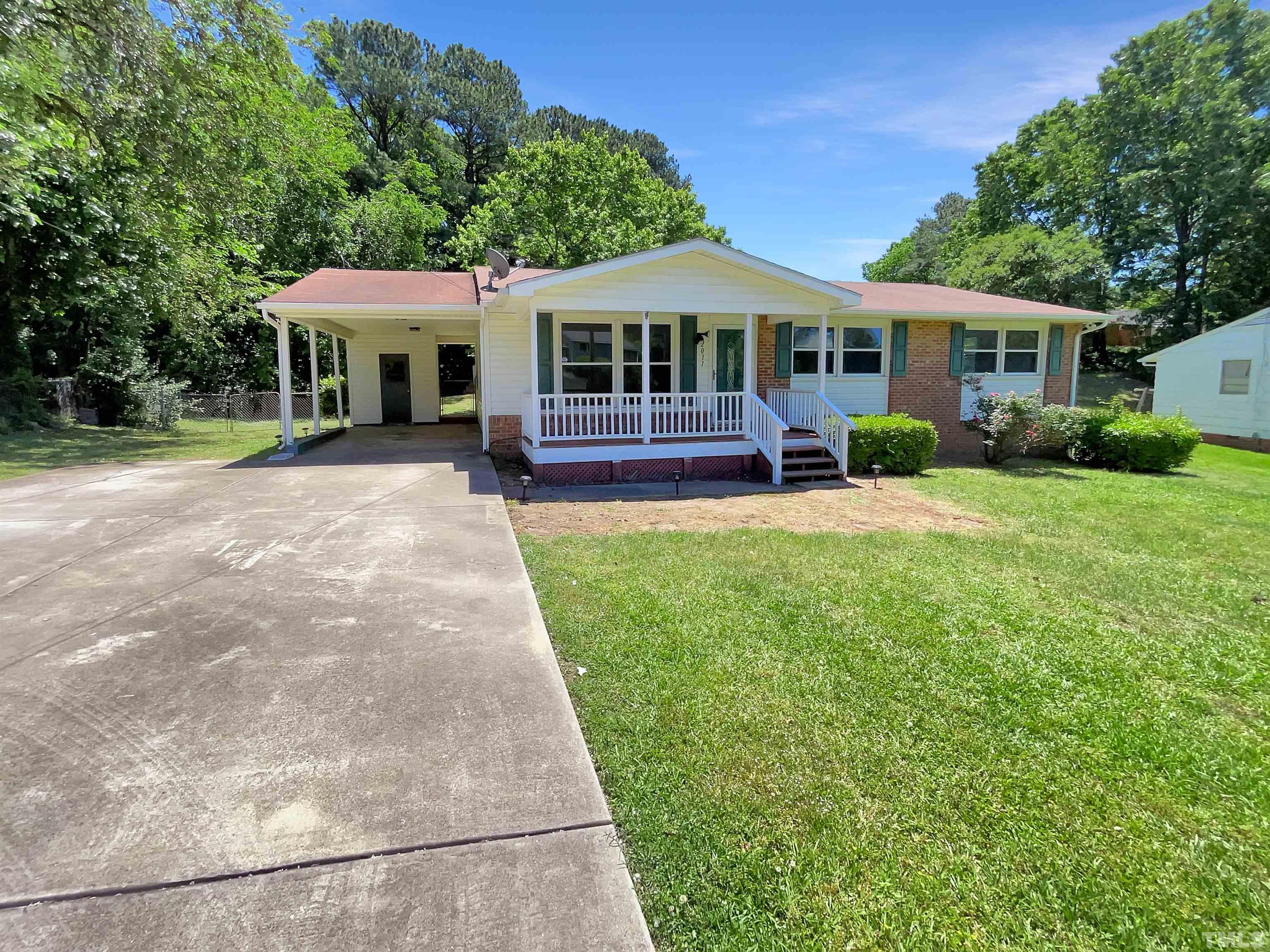 2011 Waters Drive Raleigh, NC 27610 - Photo 1 of 18 a front view of a house with a garden