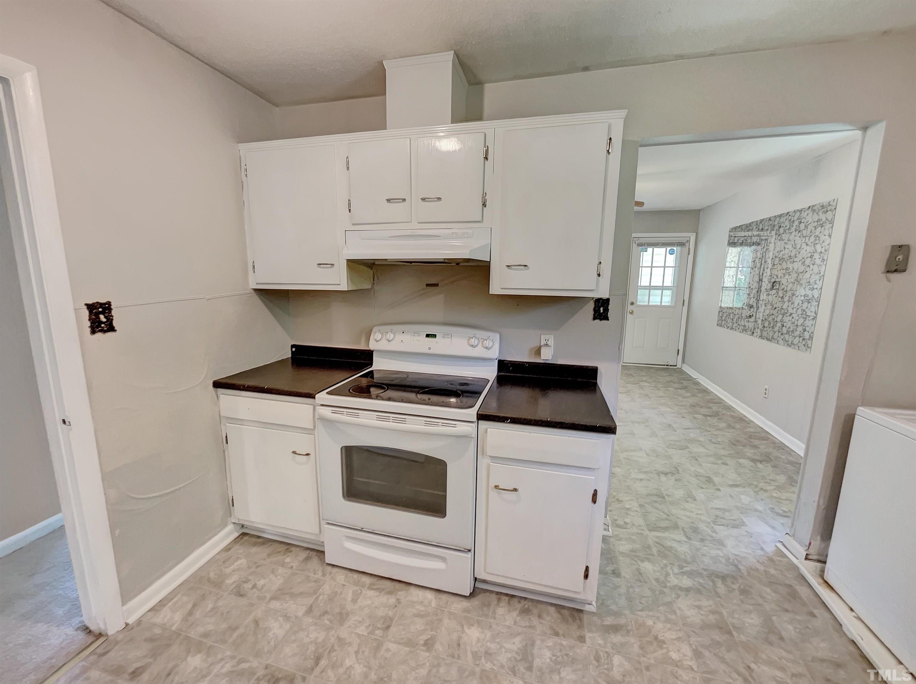 2011 Waters Drive Raleigh, NC 27610 - Photo 12 of 18 a kitchen with granite countertop a stove a sink and a white cabinets