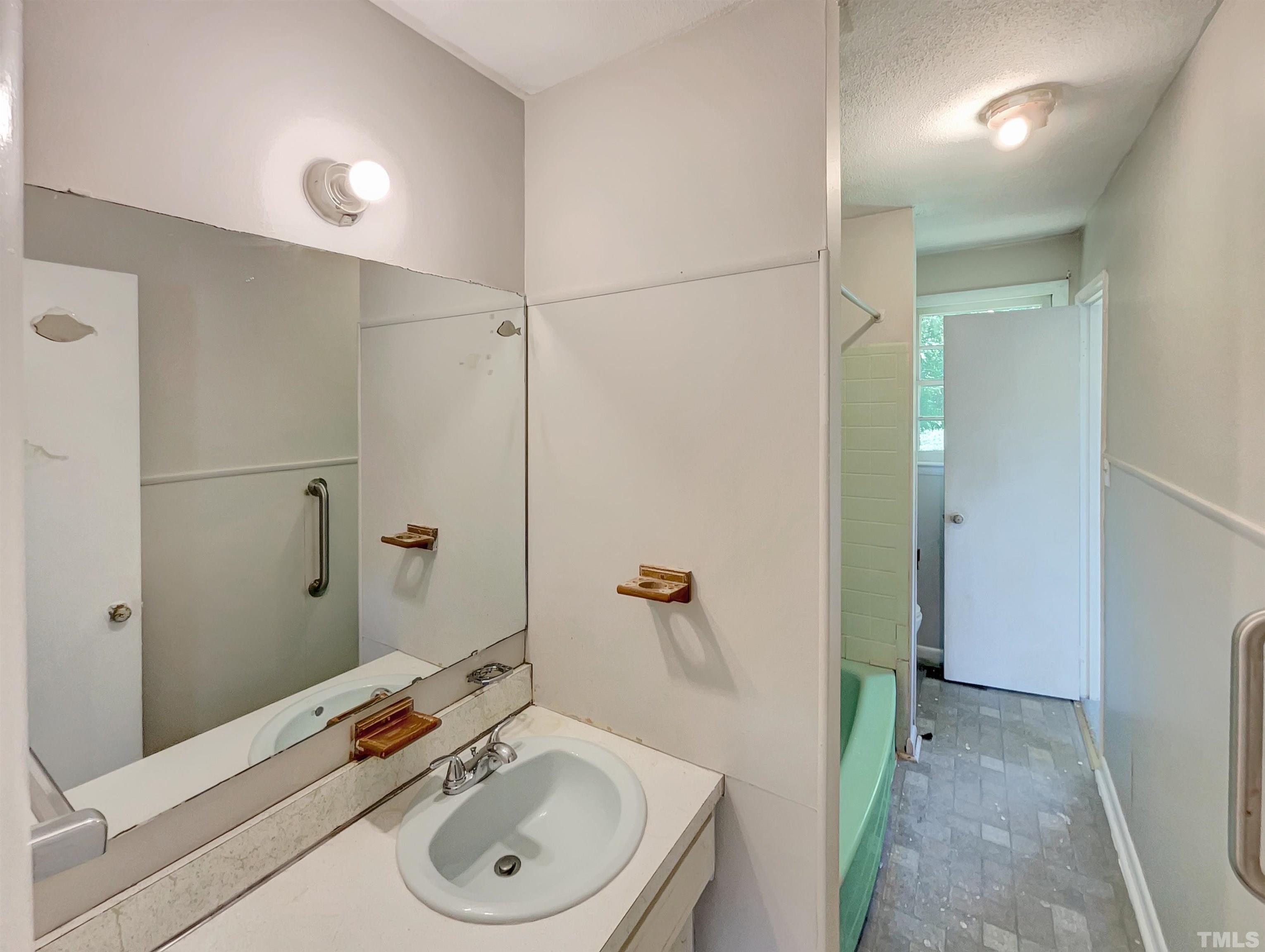 2011 Waters Drive Raleigh, NC 27610 - Photo 14 of 18 a bathroom with a sink a toilet and shower