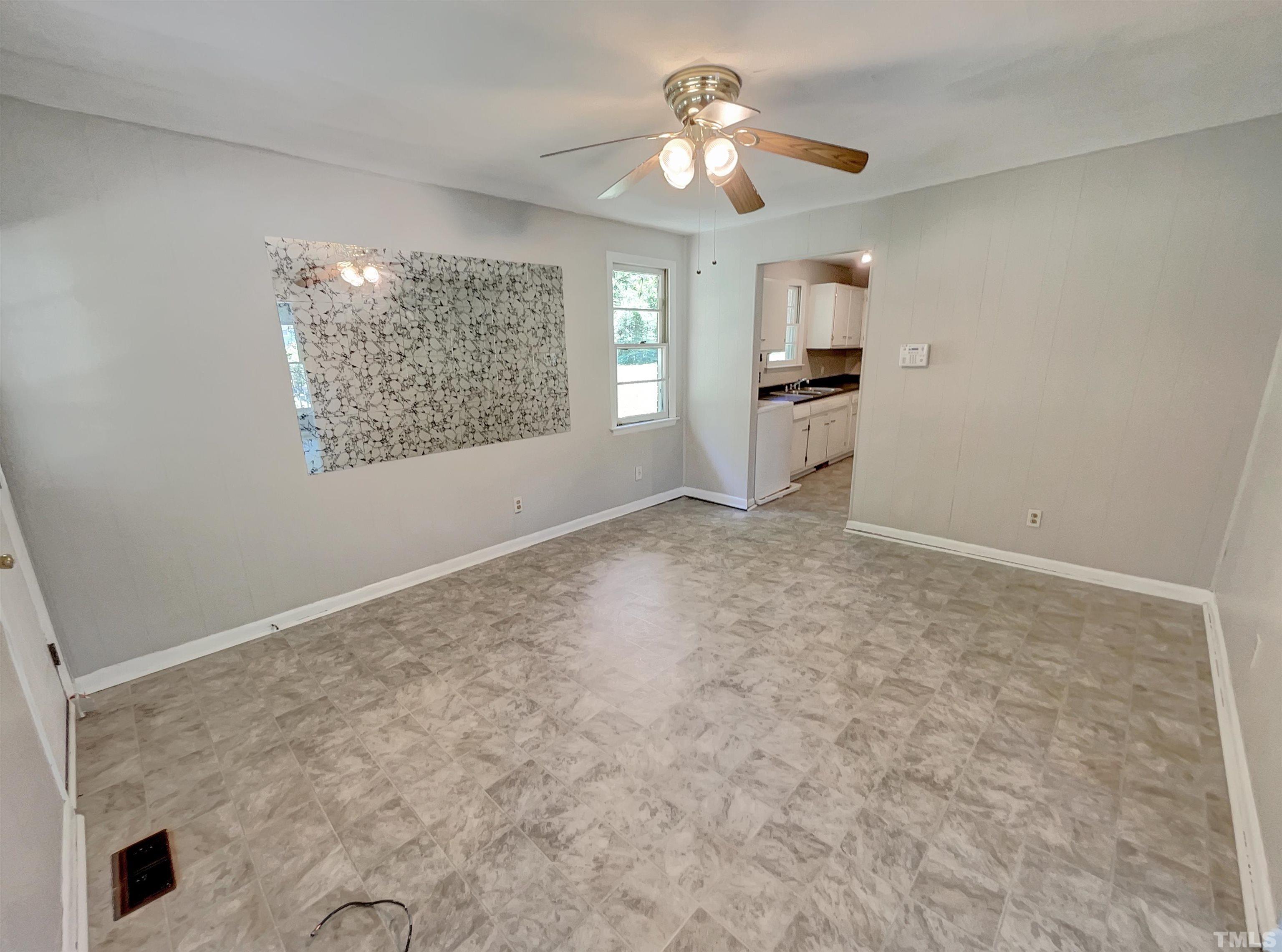 2011 Waters Drive Raleigh, NC 27610 - Photo 6 of 18 an empty room with windows and ceiling fan
