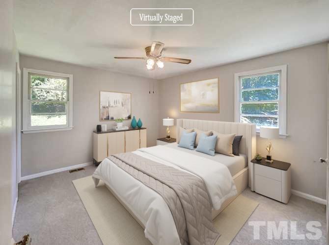 2011 Waters Drive Raleigh, NC 27610 - Photo 7 of 18 a bedroom with a large bed and a window