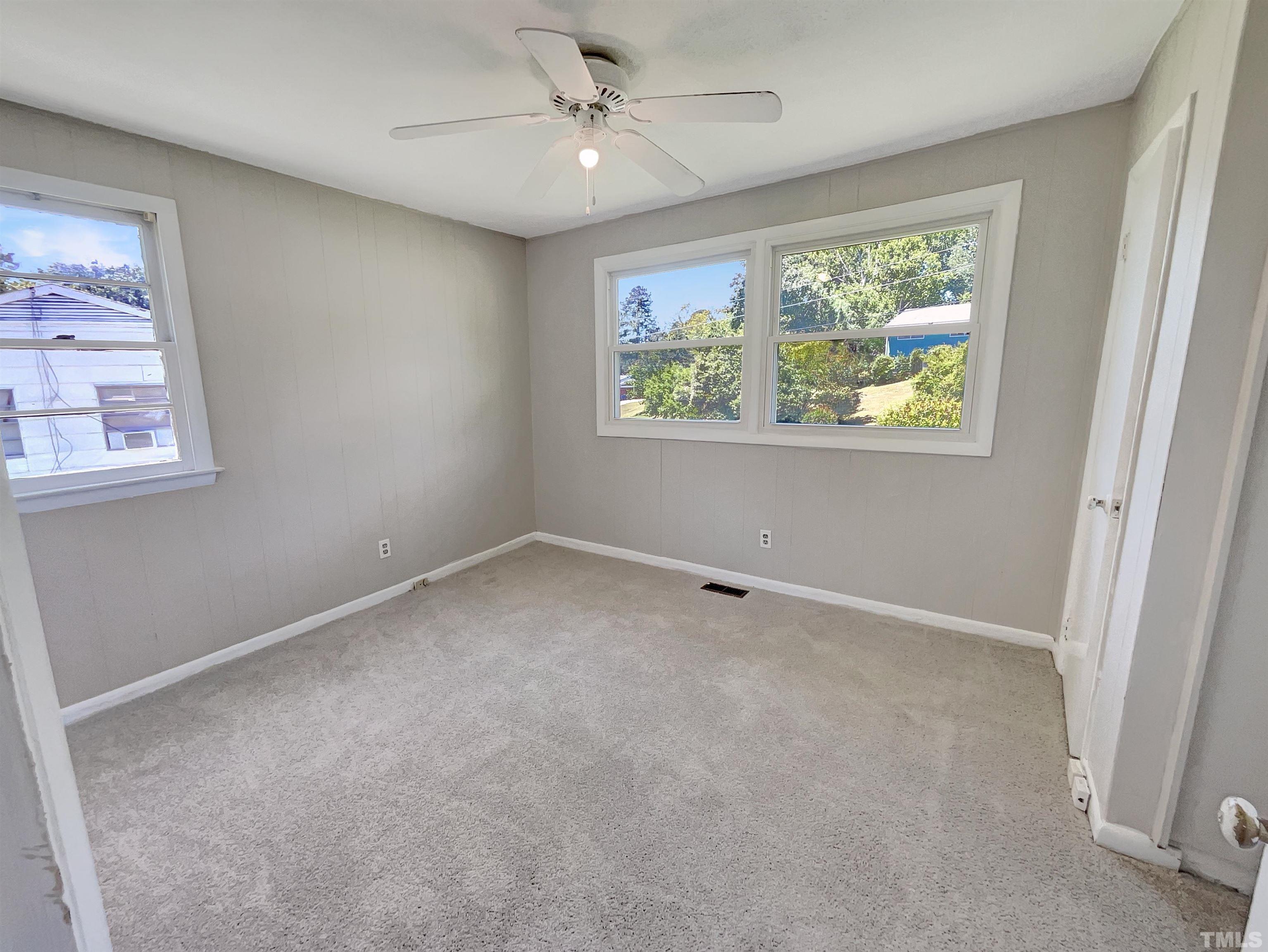 2011 Waters Drive Raleigh, NC 27610 - Photo 10 of 18 an empty room with windows and ceiling fan