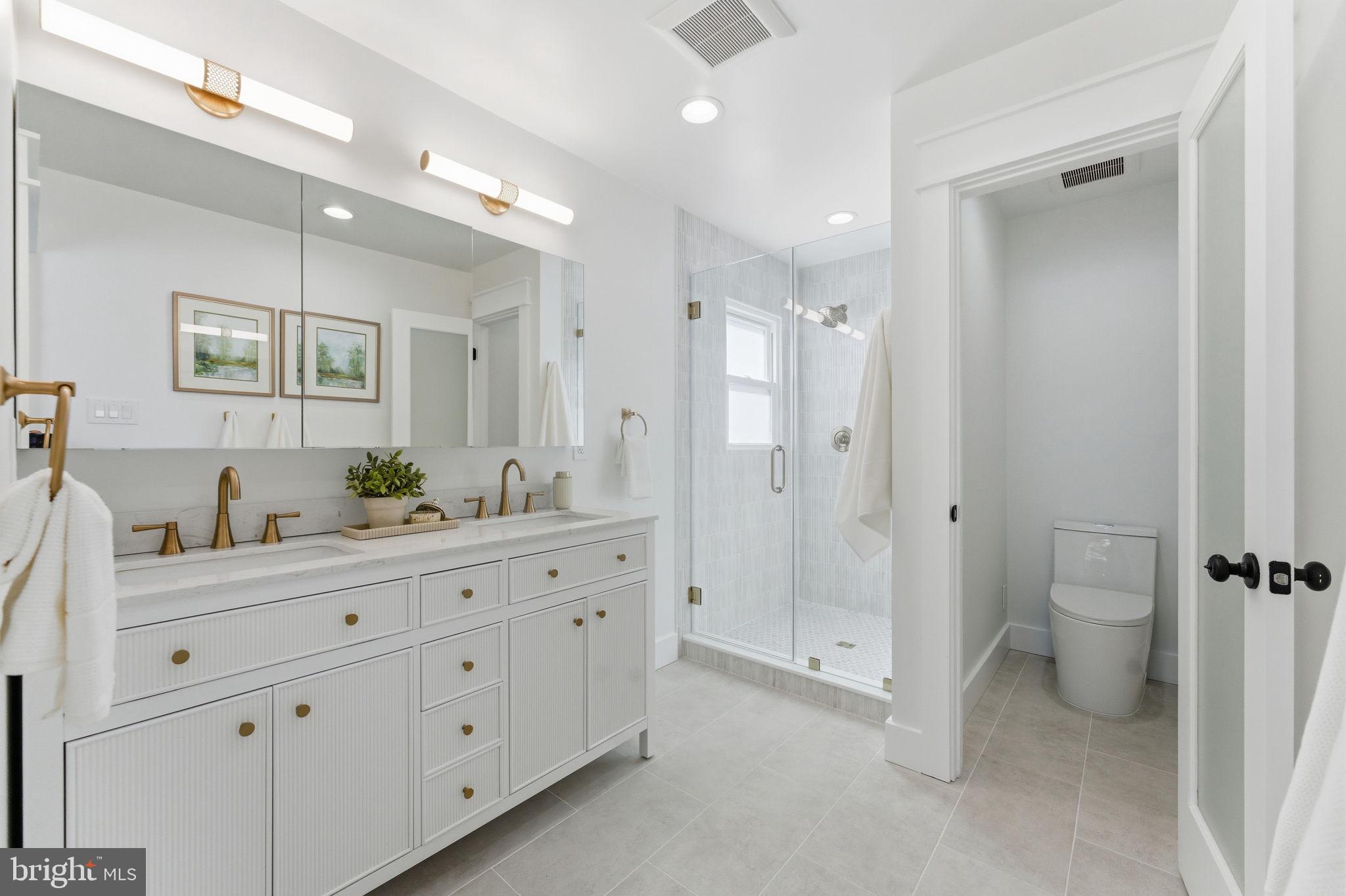 8615 Kerry Lane Springfield, VA 22152 - Photo 15 of 50 a spacious bathroom with a granite countertop sink mirror and toilet