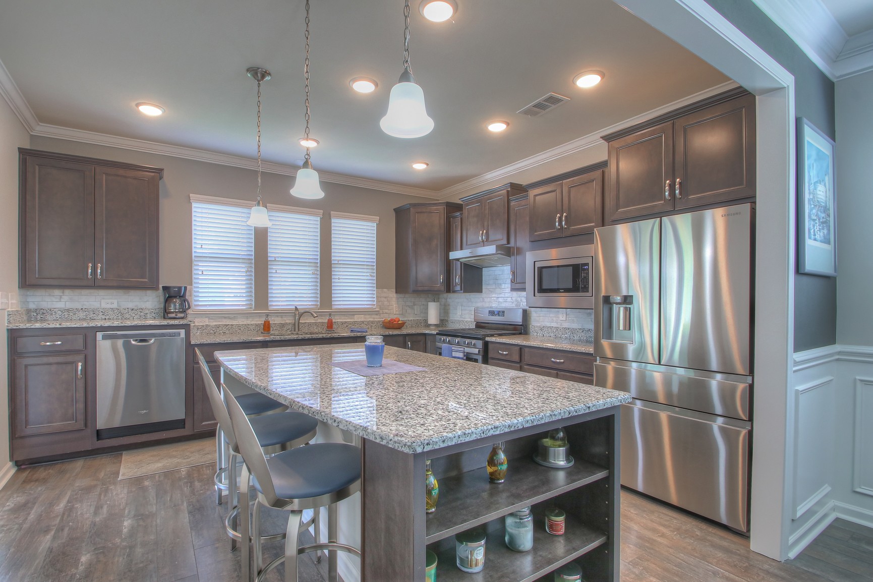 104 Tipton Pass Spring Hill, TN 37174 - Photo 12 of 40 a kitchen with a table chairs refrigerator and microwave