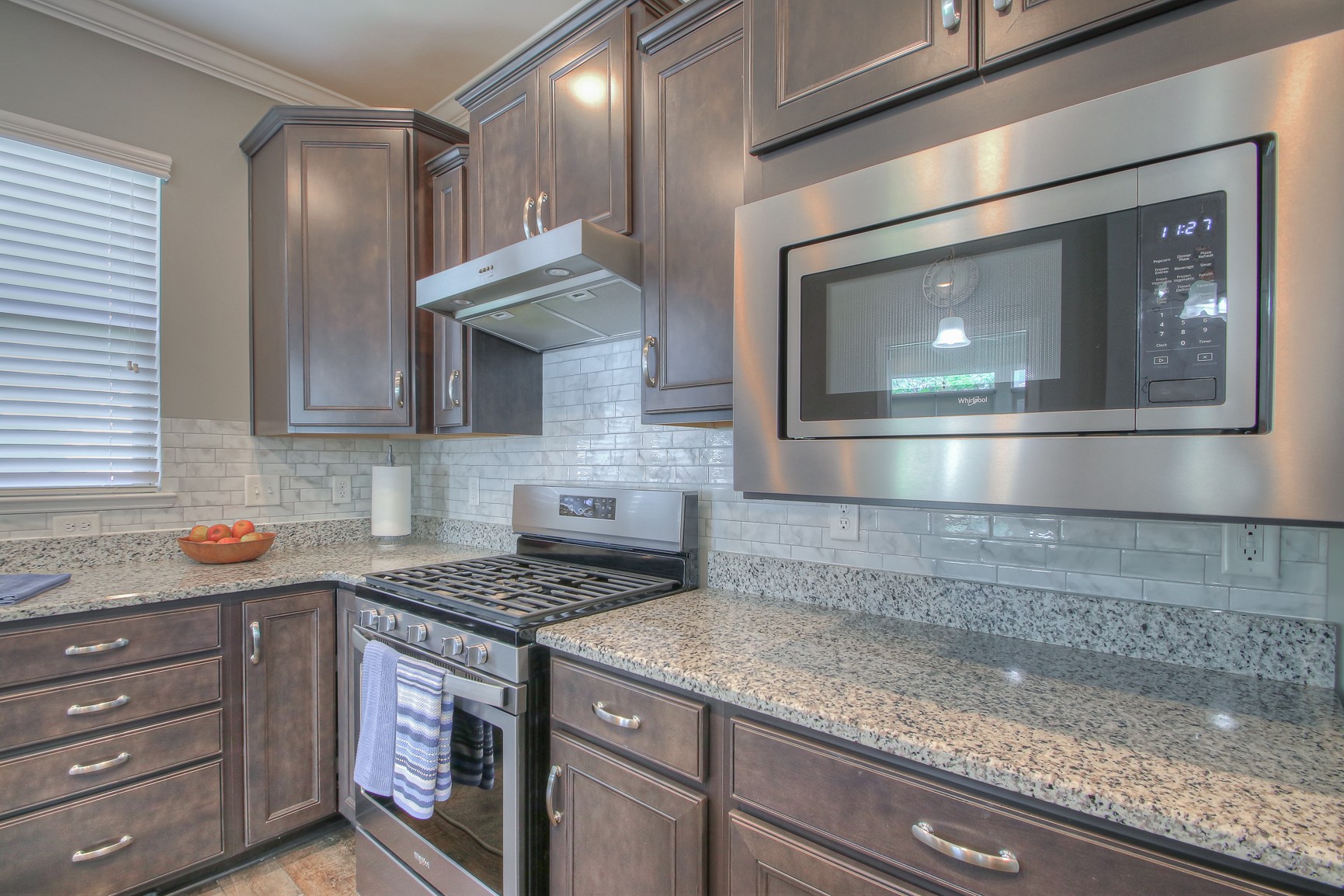 104 Tipton Pass Spring Hill, TN 37174 - Photo 16 of 40 a kitchen with stainless steel appliances granite countertop a sink and a stove