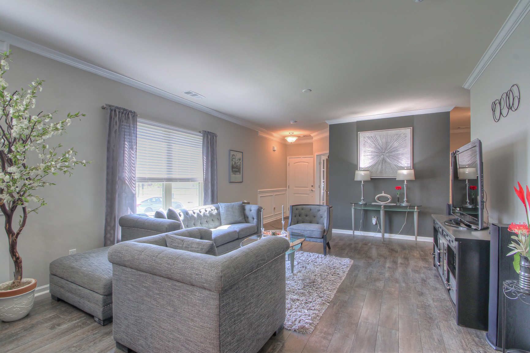 104 Tipton Pass Spring Hill, TN 37174 - Photo 7 of 40 a living room with furniture and a flat screen tv