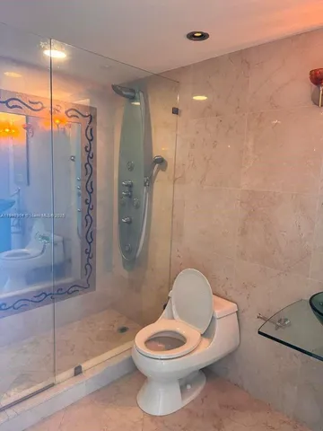 a bathroom with a toilet a sink and shower