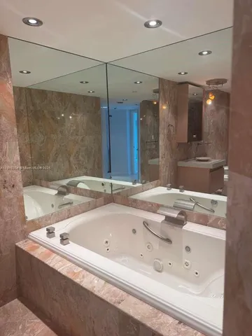 a bathroom with a bathtub and a shower