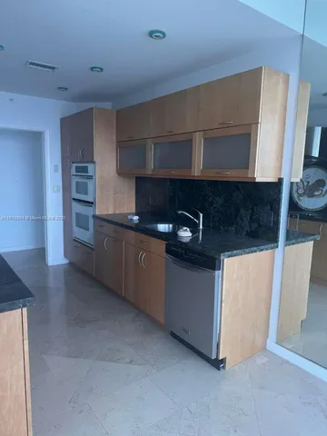 a kitchen with stainless steel appliances granite countertop a stove and a microwave