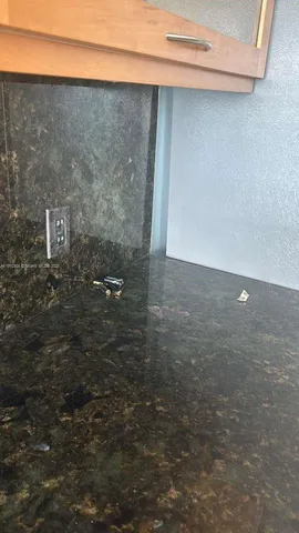 a kitchen with a sink and large window