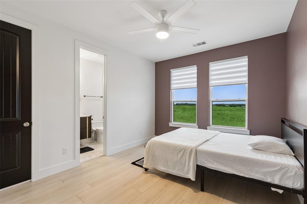 1053 Sedalia Road Van Alstyne, TX 75495 - Photo 18 of 40 a bedroom with a large bed and a large window