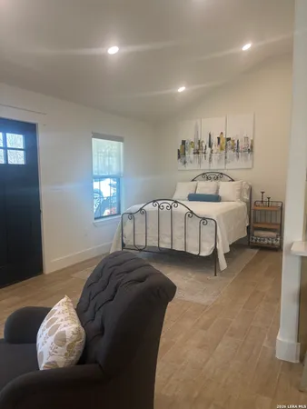 a spacious bedroom with a bed and window