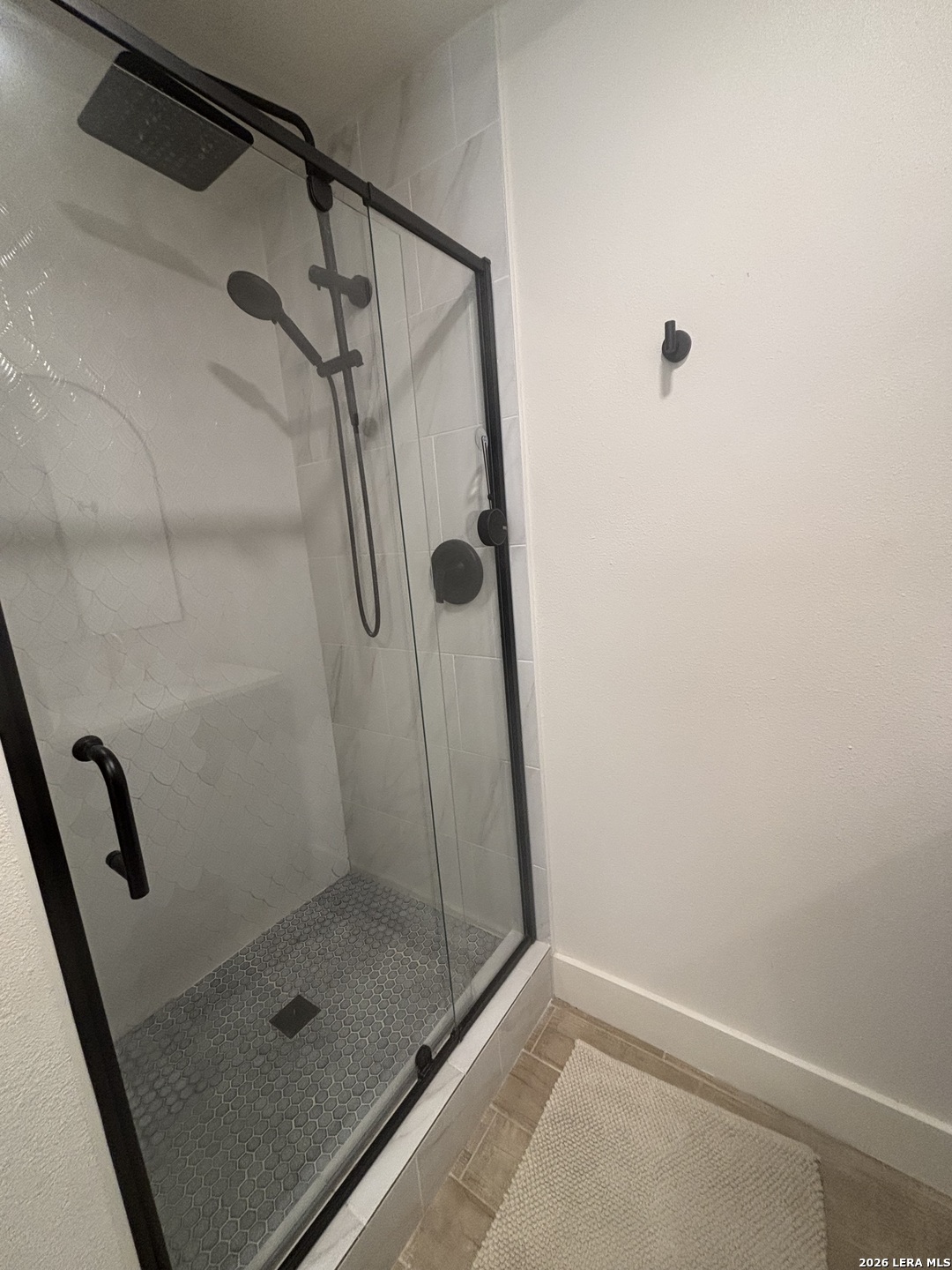 18014 Scenic Loop Road, Unit A Helotes, TX 78023 - Photo 12 of 22 a bathroom with a glass door shower