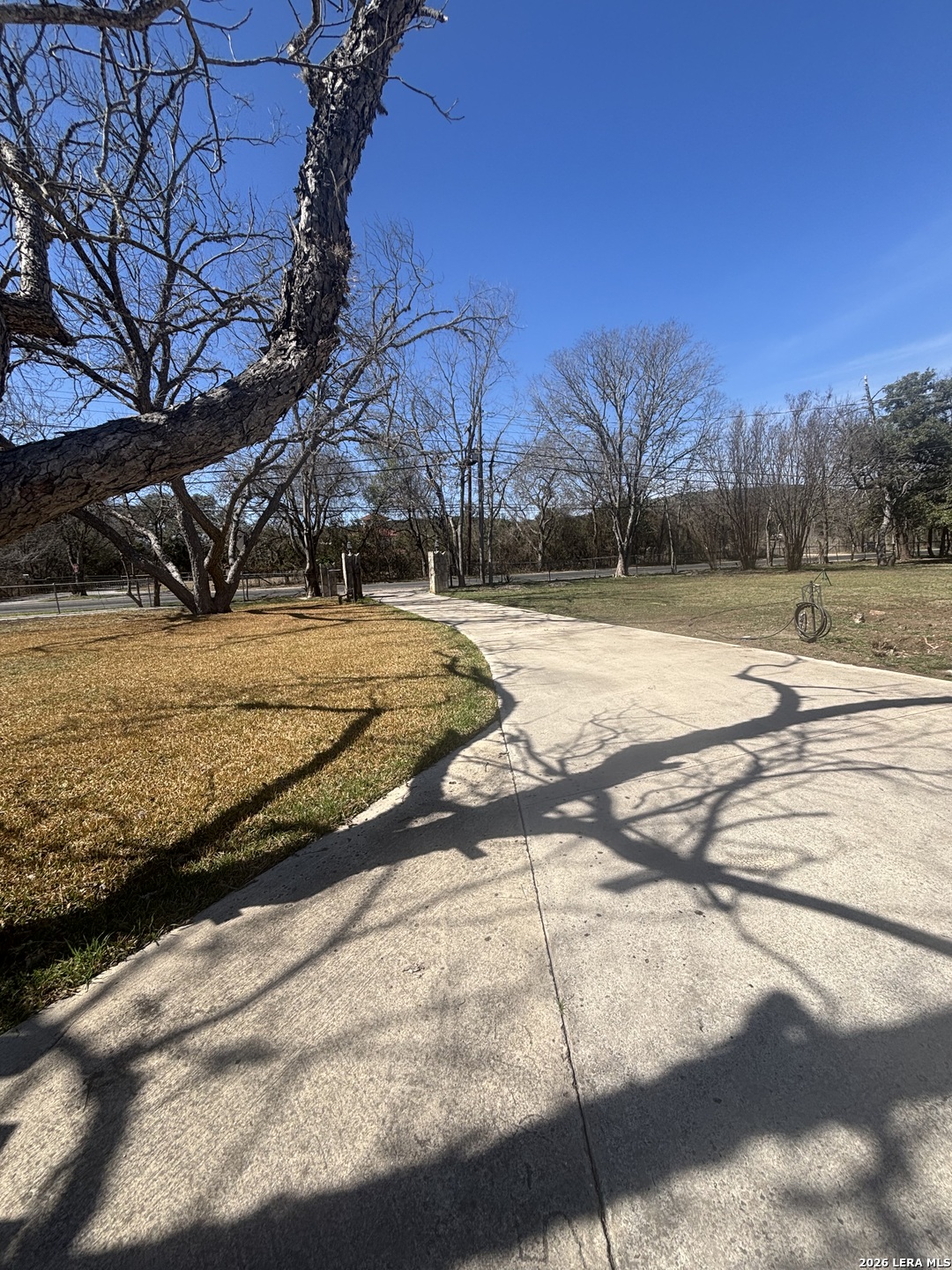 18014 Scenic Loop Road, Unit A Helotes, TX 78023 - Photo 18 of 22 a view of a yard with street