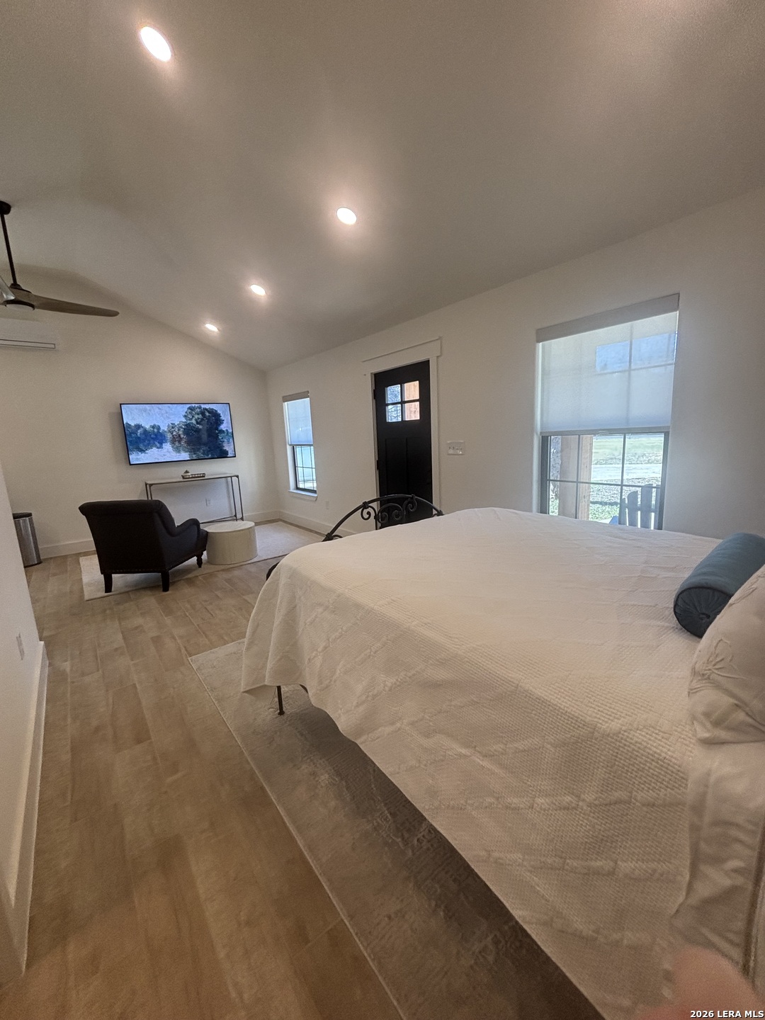 18014 Scenic Loop Road, Unit A Helotes, TX 78023 - Photo 2 of 22 a bed room with a bed and a large mirror