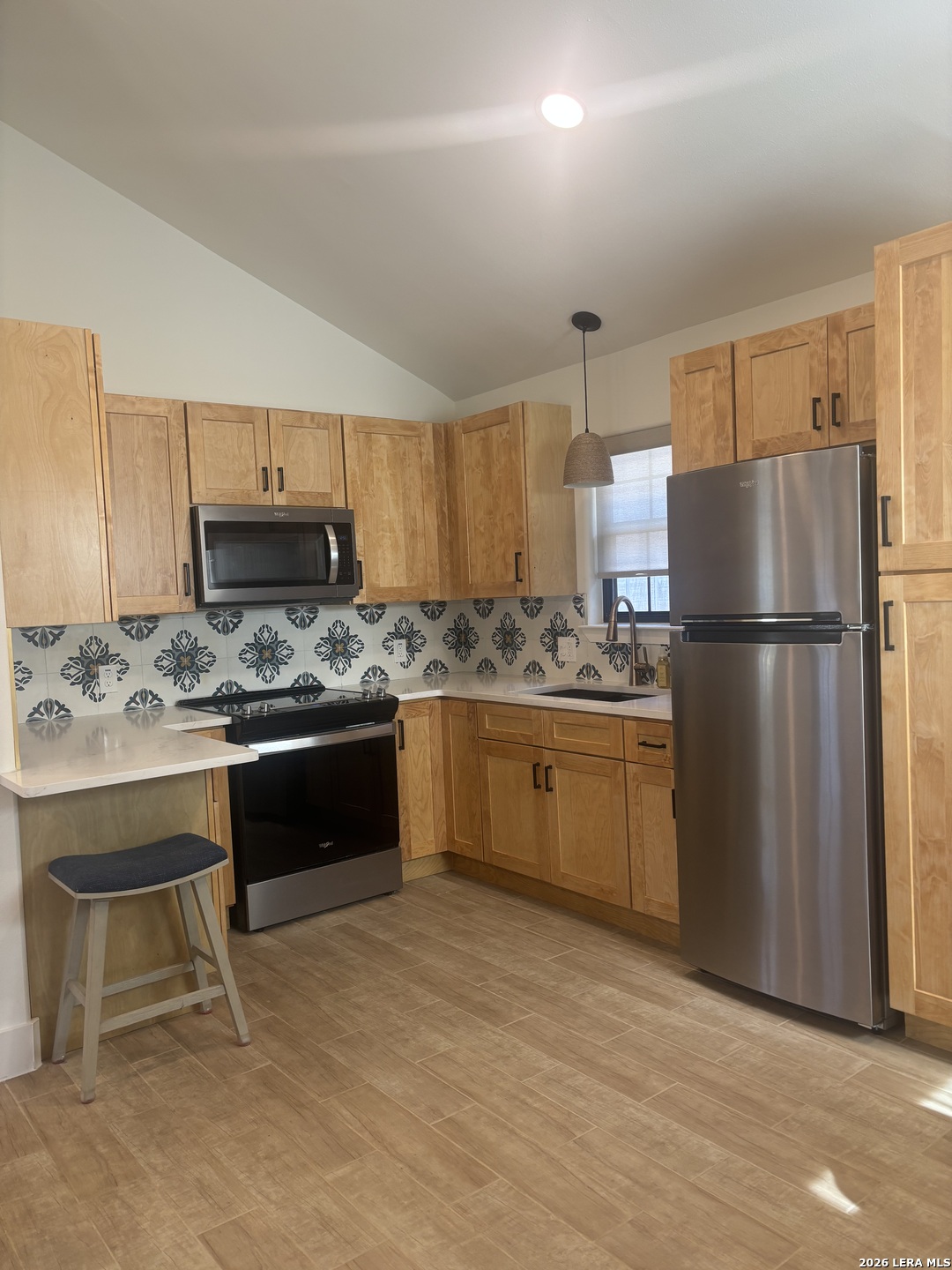 18014 Scenic Loop Road, Unit A Helotes, TX 78023 - Photo 22 of 22 a kitchen with a refrigerator and a stove top oven