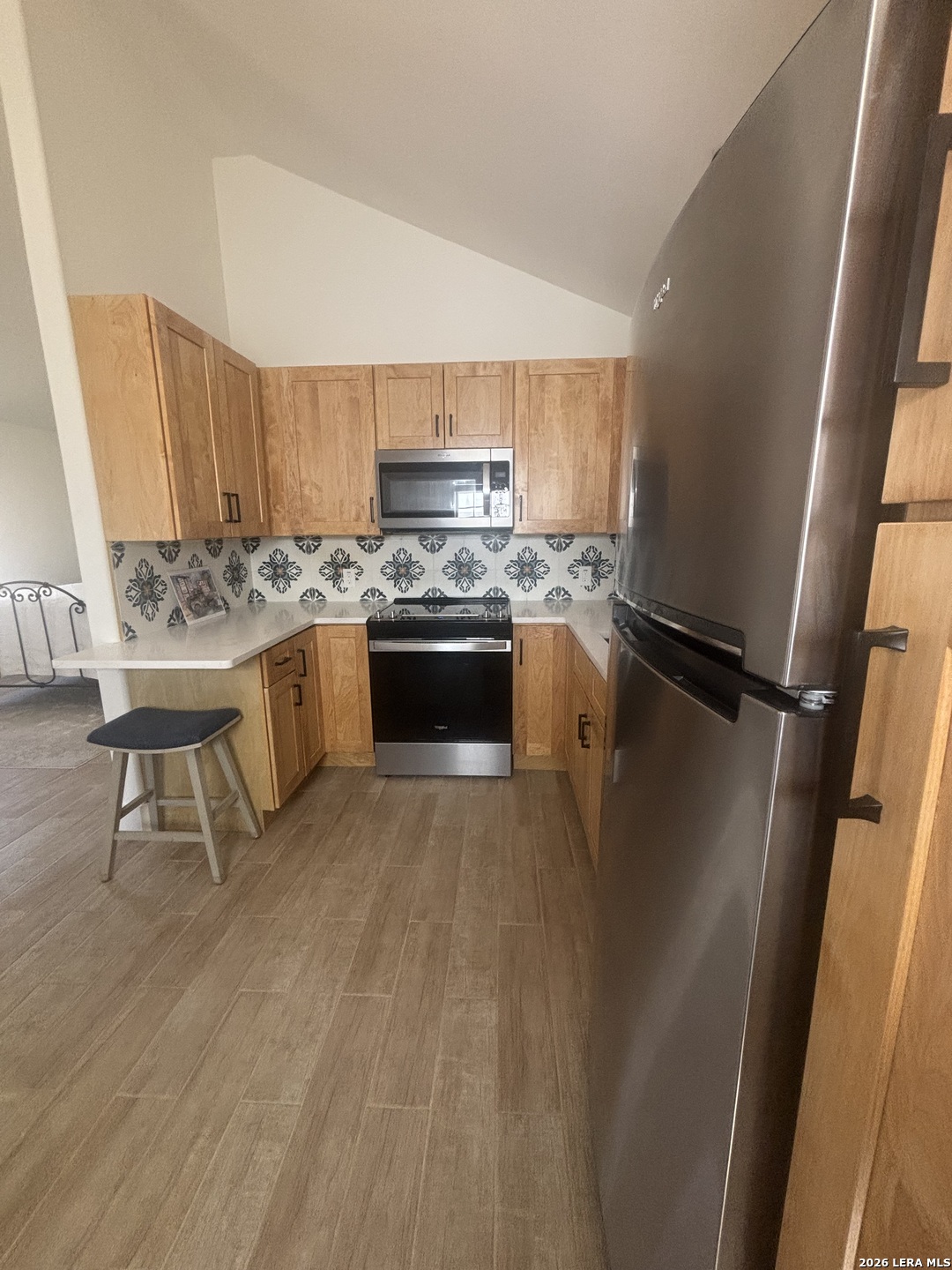 18014 Scenic Loop Road, Unit A Helotes, TX 78023 - Photo 5 of 22 a kitchen with stainless steel appliances granite countertop a stove refrigerator and a sink
