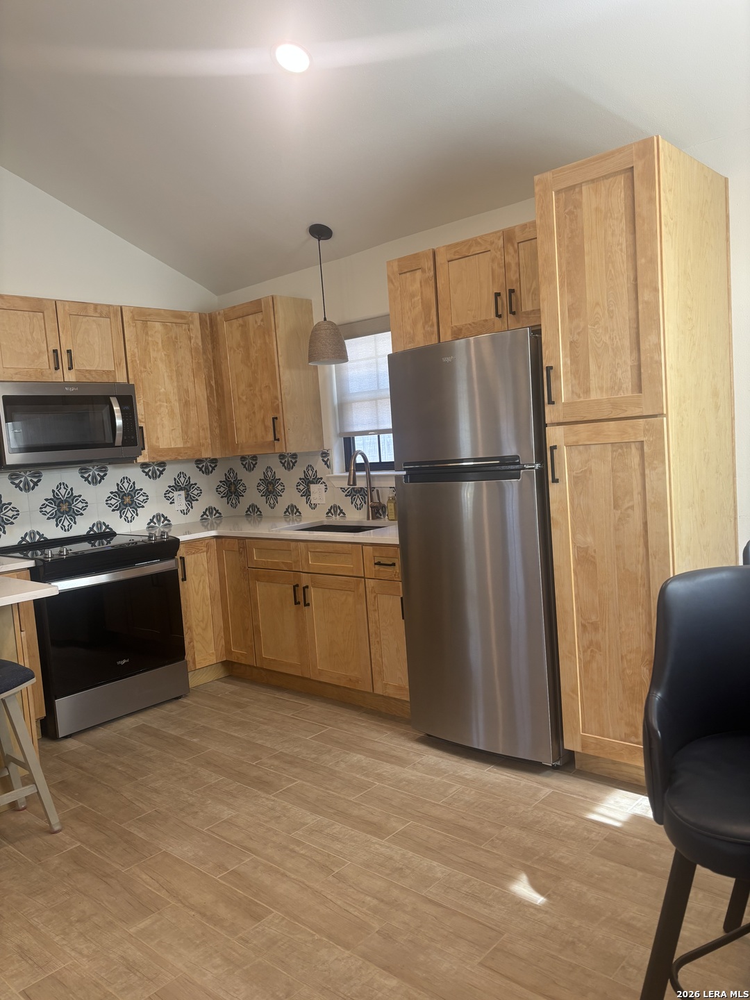 18014 Scenic Loop Road, Unit A Helotes, TX 78023 - Photo 7 of 22 a kitchen with stainless steel appliances granite countertop a refrigerator a stove a sink and a refrigerator