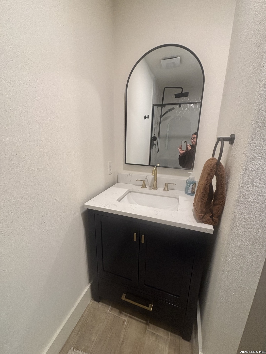 18014 Scenic Loop Road, Unit A Helotes, TX 78023 - Photo 9 of 22 a bathroom with a sink and a mirror