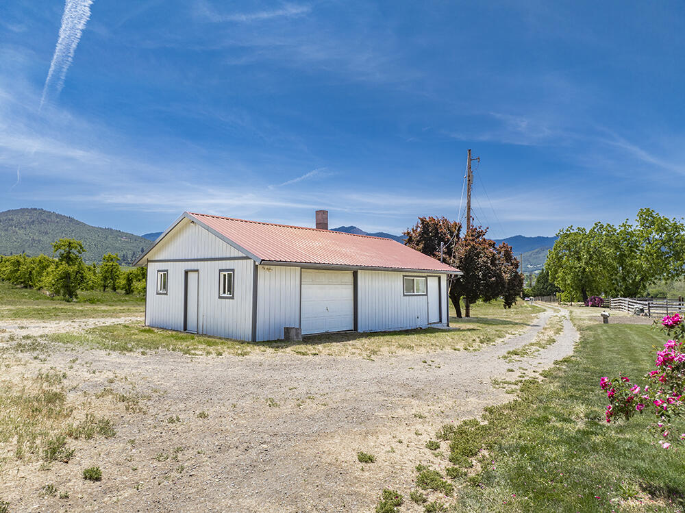 679 West Valley View Road Talent, OR 97540 - Photo 16 of 77 a front view of a house with a garden and yard