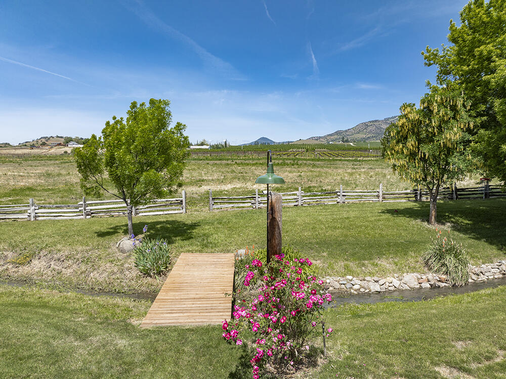 679 West Valley View Road Talent, OR 97540 - Photo 54 of 77 a view of a garden with a large tree