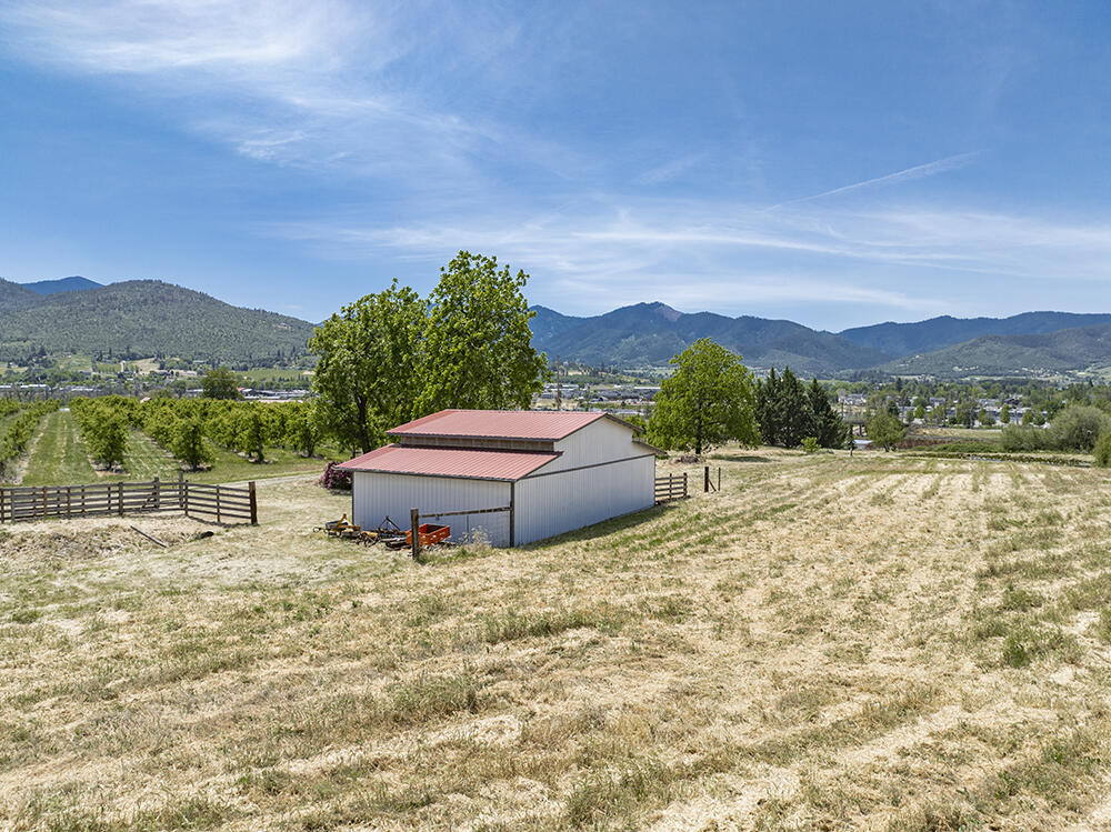 679 West Valley View Road Talent, OR 97540 - Photo 61 of 77 a backyard of a house with a yard and mountain view in back