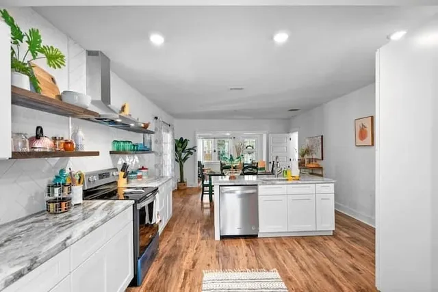 a kitchen with stainless steel appliances granite countertop a stove and a sink