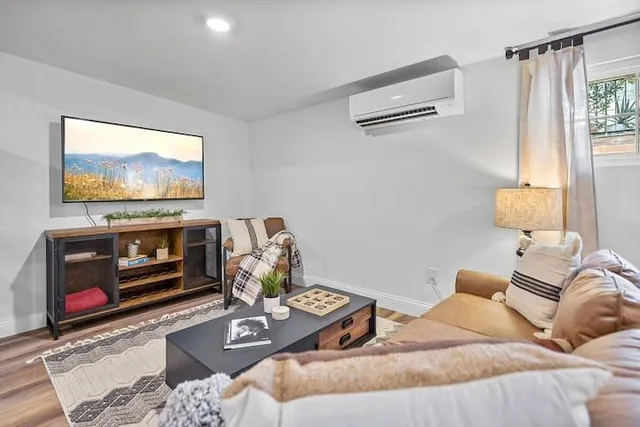 a living room with furniture and wooden floor