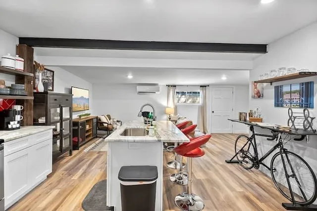 a living room with furniture a flat screen tv and a table