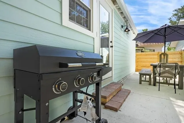 a roof deck with a table and chairs under an umbrella