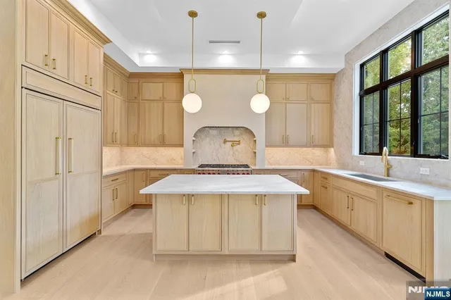 a view of a kitchen with a sink and a refrigerator