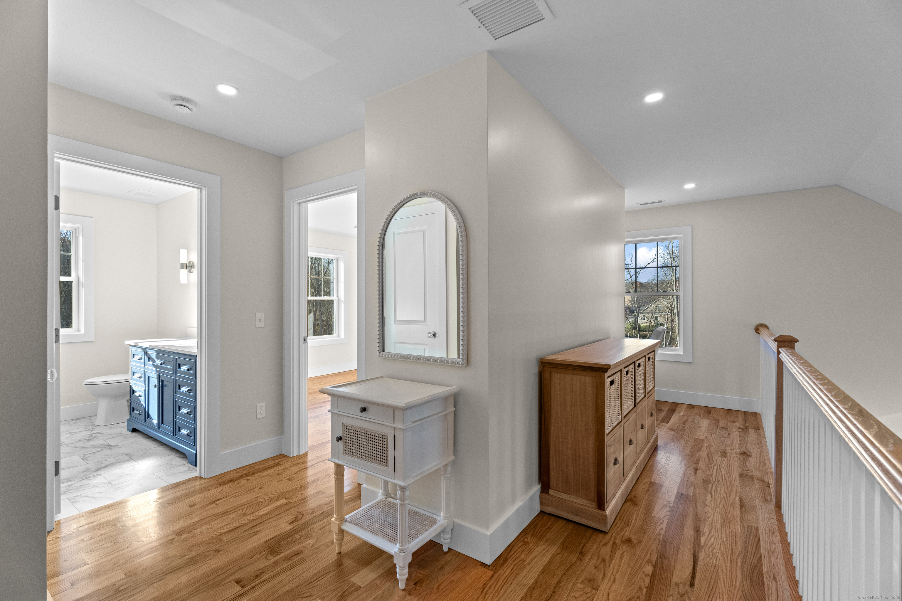 26 Ivy Hill Road, Unit 26 Waterford, CT 06385 - Photo 18 of 39 a view of a hallway with wooden floor windows and a kitchen