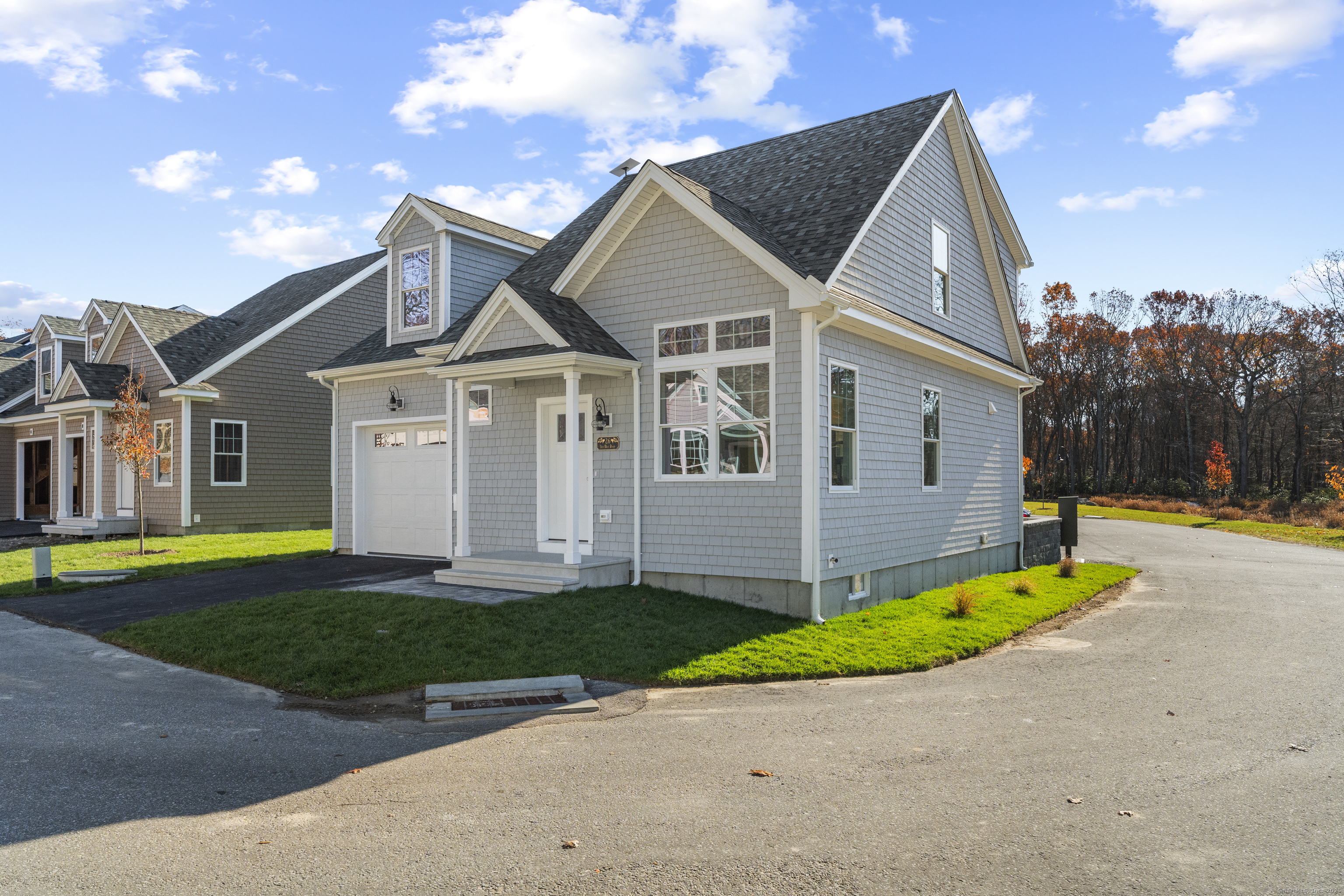 26 Ivy Hill Road, Unit 26 Waterford, CT 06385 - Photo 25 of 39 a front view of a house with a yard and garage