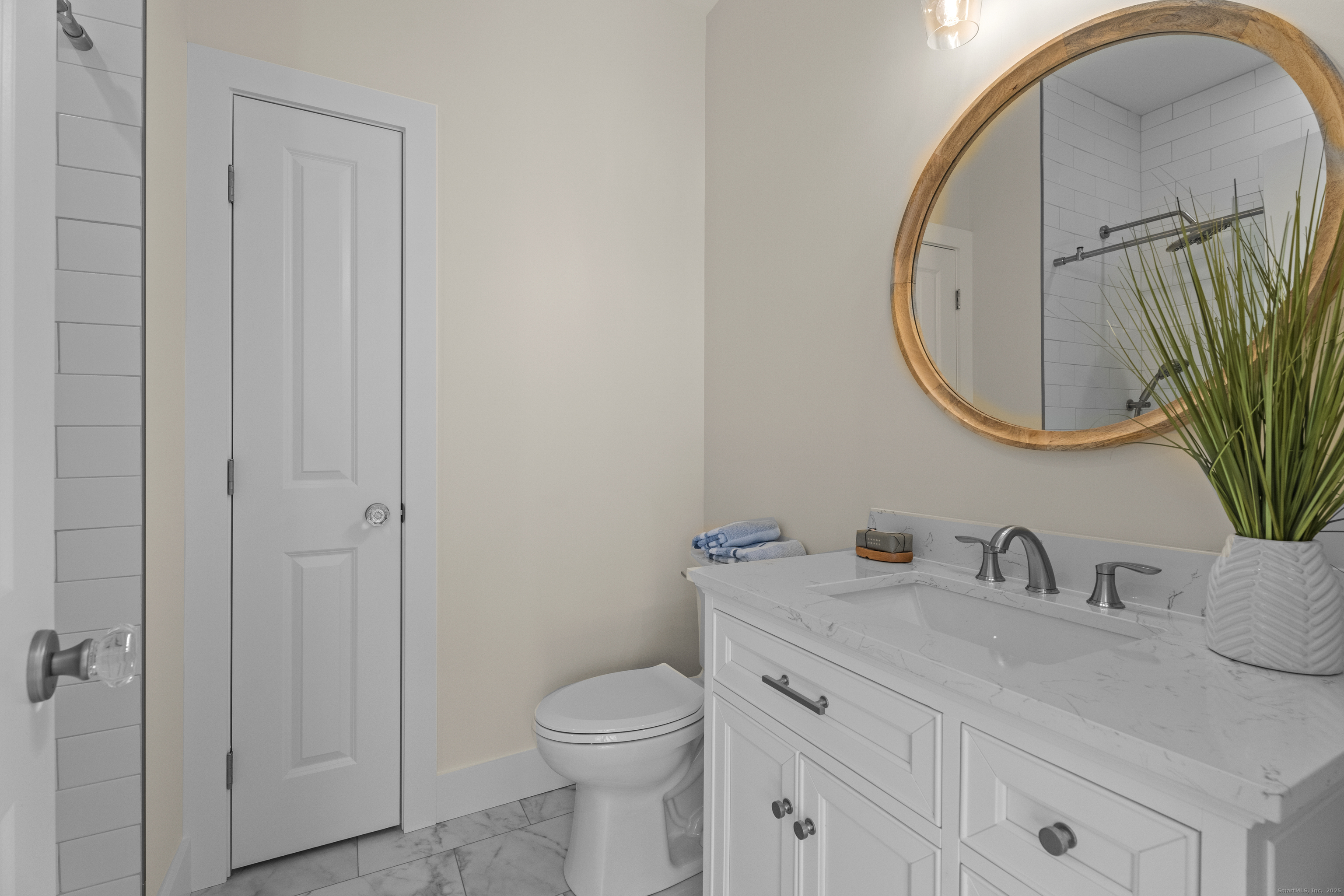 26 Ivy Hill Road, Unit 26 Waterford, CT 06385 - Photo 10 of 39 a bathroom with a toilet a sink a mirror and vanity