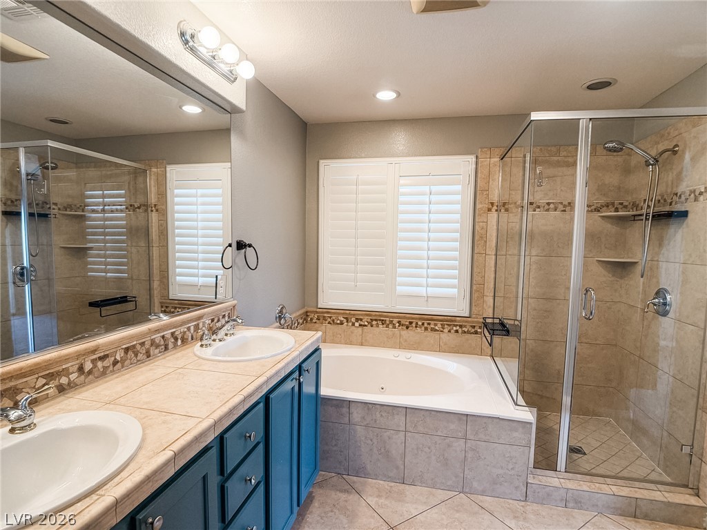 8683 Moreno Mountain Avenue Las Vegas, NV 89178 - Photo 18 of 26 Indulge in a primary bathroom designed for relaxation with a spacious soaking tub and an adjoining walk-in shower.