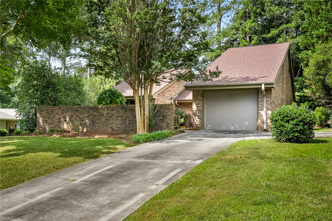 34 Hickory Way Clemson, SC 29631 - Photo 2 of 39 A well-maintained concrete driveway leads to the garage of this charming brick-exterior home.