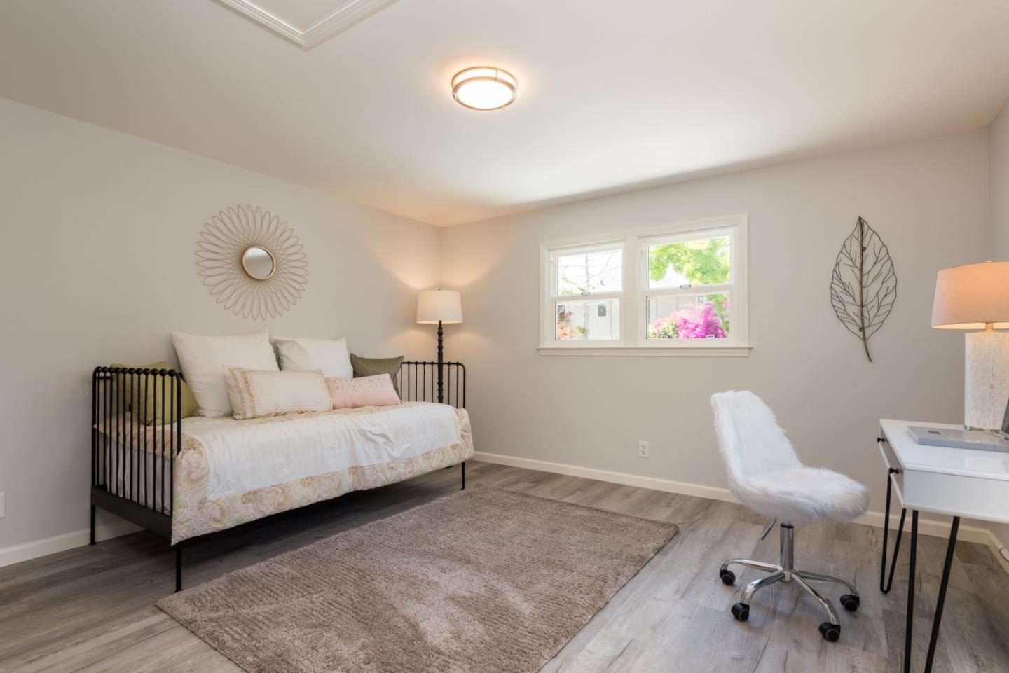 739 Prospect Row San Mateo, CA 94401 - Photo 14 of 27 a bedroom with a bed and a chair