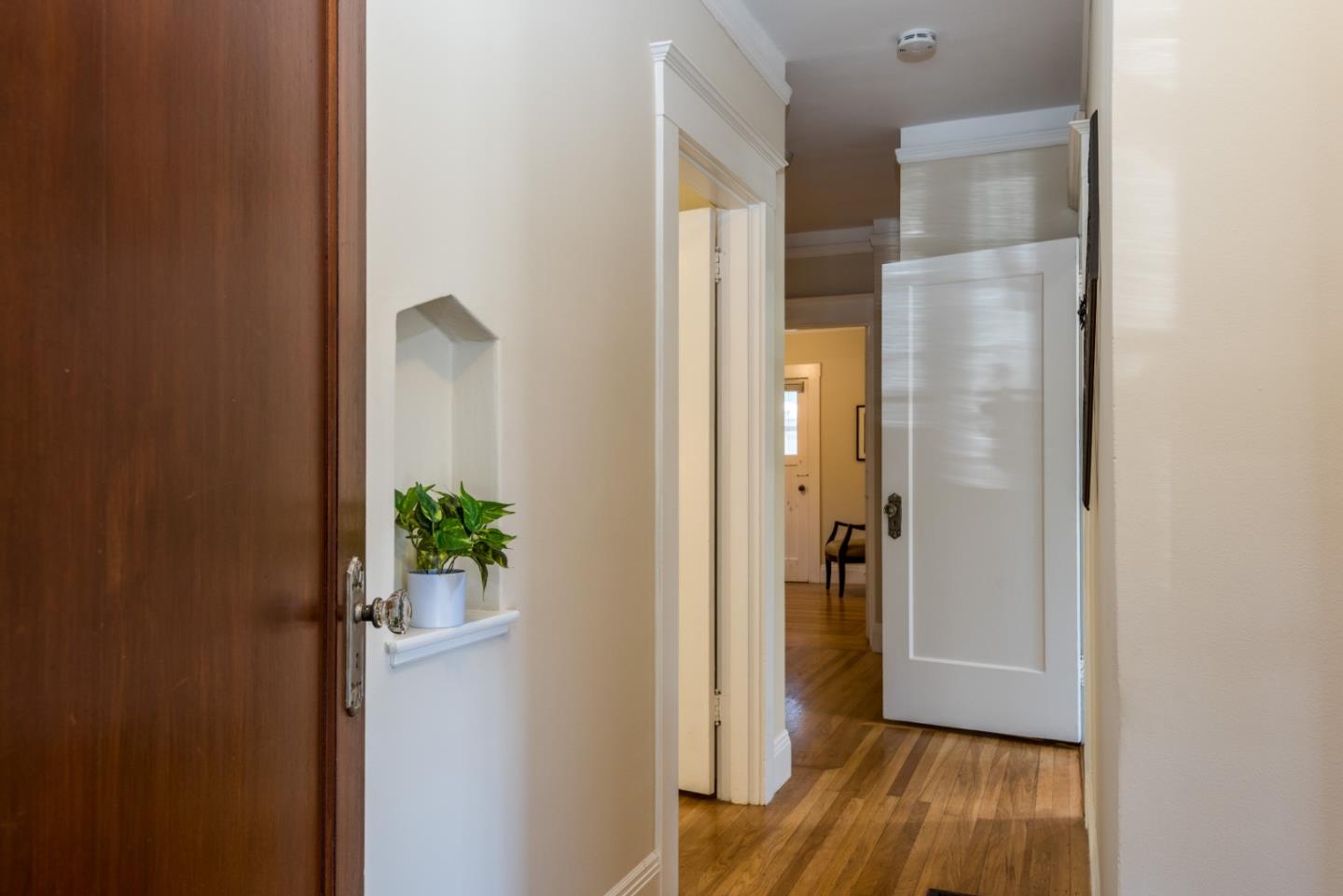 739 Prospect Row San Mateo, CA 94401 - Photo 15 of 27 a view of a hallway with wooden floor and a bathroom